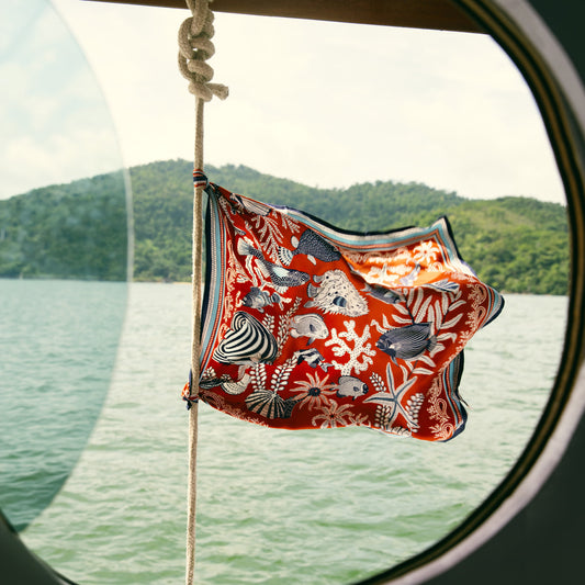 Inoui Editions Neptune pure silk carre, terracotta, blue and white scarf with marine life design on a white background.