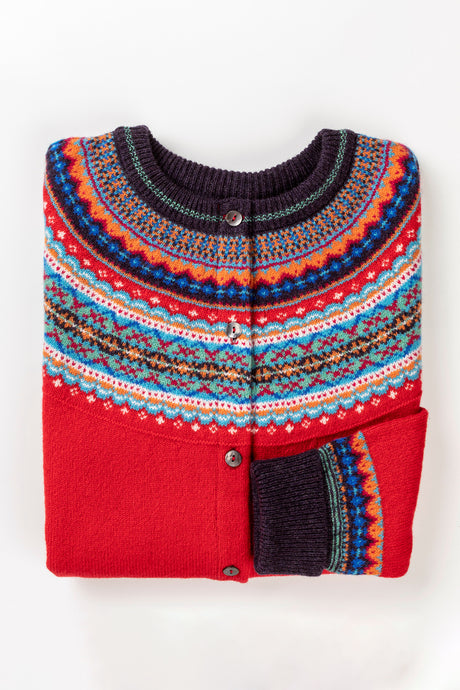 Eribe Alpine short cardigan in Crabapple, bright red with shades of blue and orange.