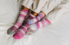 Load image into Gallery viewer, Solmate baby socks, two pairs and a spare knit from recycled cotton yarn in light pink, pink, purple and white.