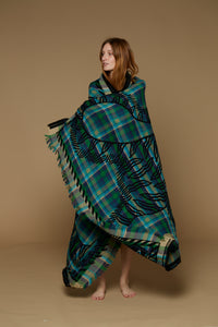 Inoui Editions wool throw, plaid in shades of blue and green with tiger silhouette in black.