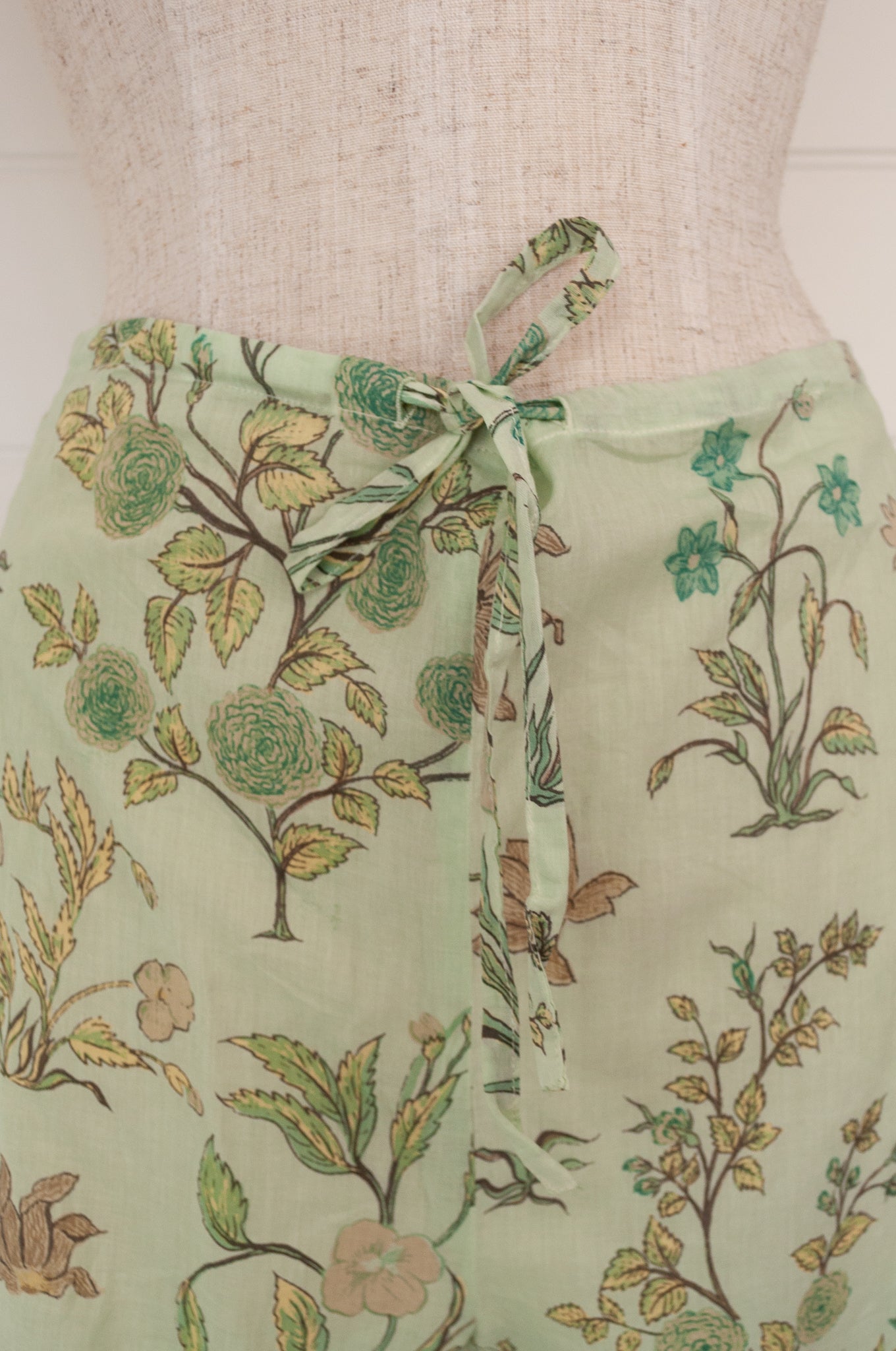 Juniper Hearth ethically made cotton voile full length pyjamas, beautiful vanilla, light turquoise and taupe floral print on soft celadon green background.