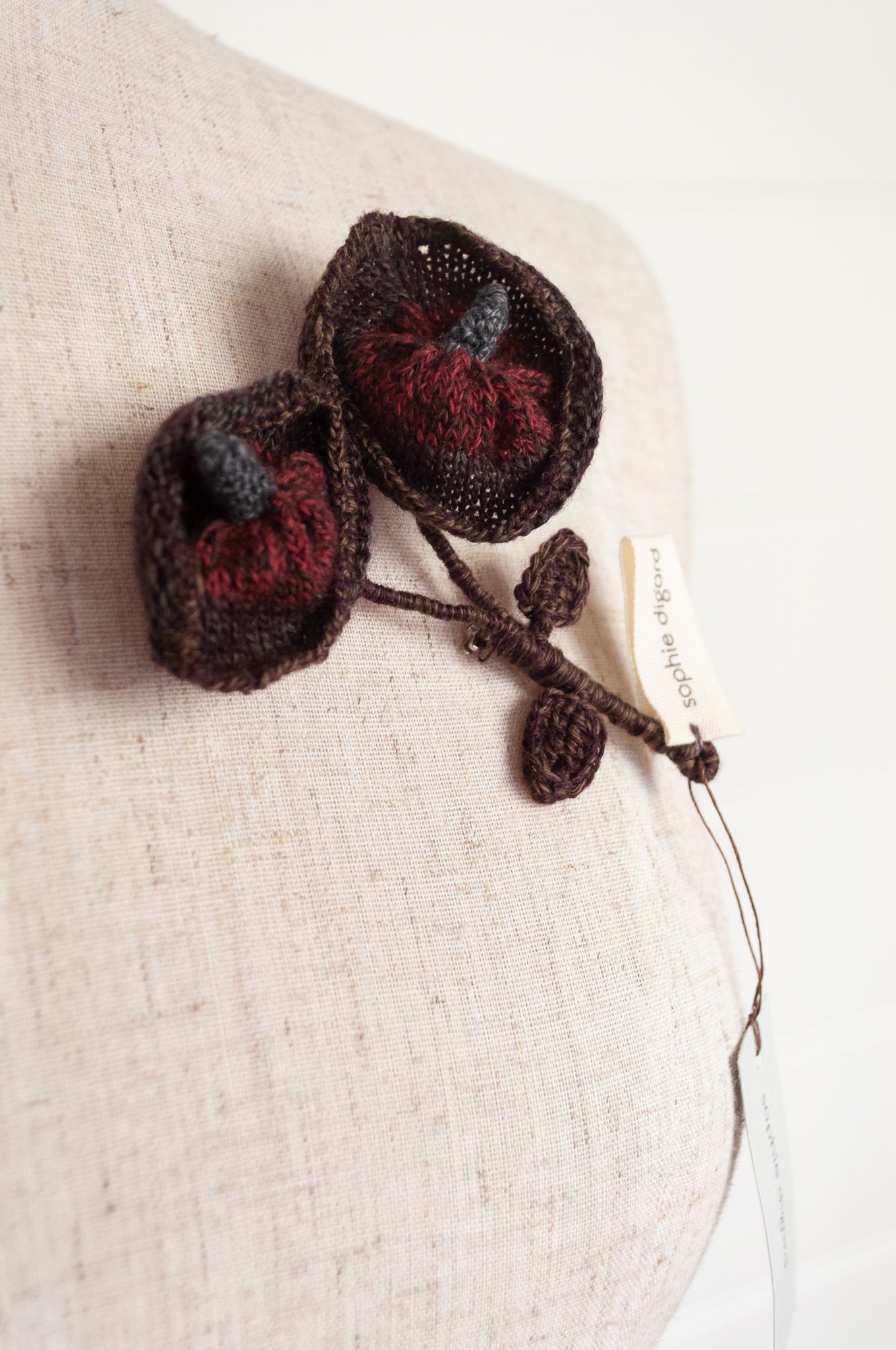 Sophie Digard Neet knitted wool brooch in Dingle colourway, chocolate brown and russet red.