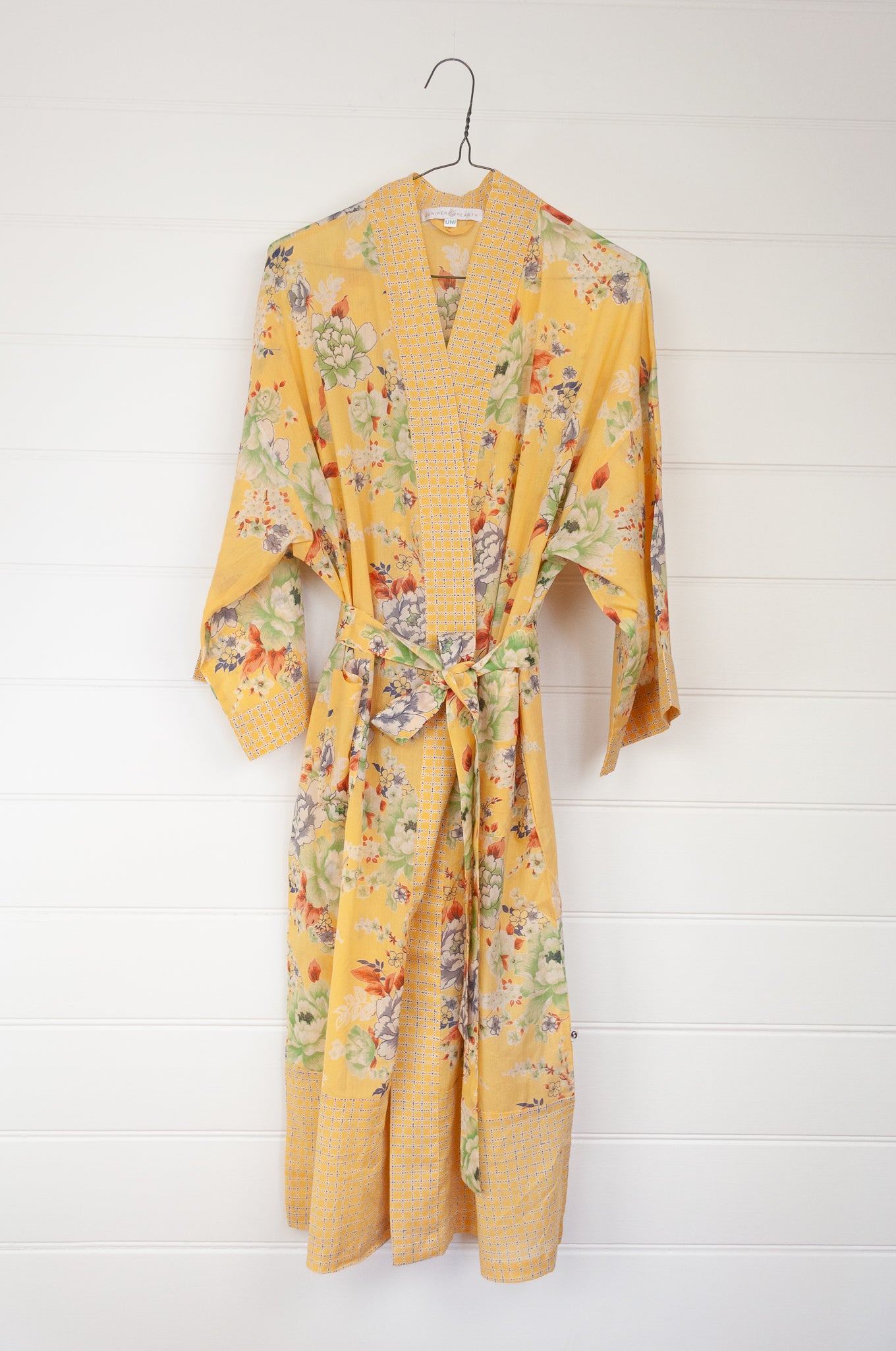 100% fine cotton voile kimono gown, screen printed by hand, peony floral print in shades of green, white, orange and grey on a butter yellow background, contrast trim. Ethically made.