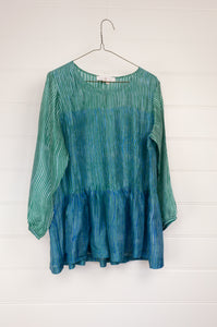 Juniper Hearth silk shibori Asha top with pin tucked bodice and long sleeves in aqua with vibrant blue accents.