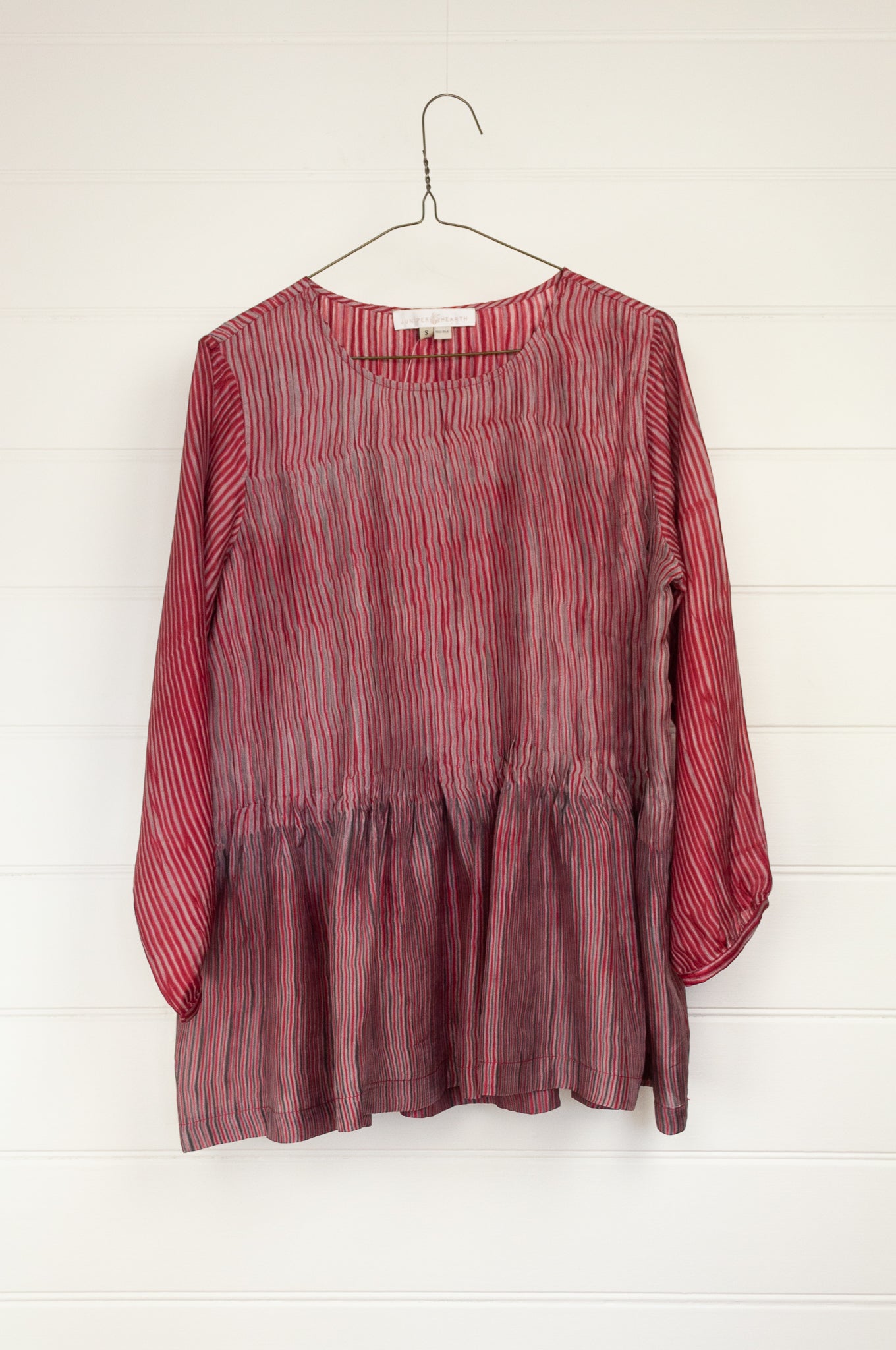 Juniper Hearth silk shibori Asha top with pin tucked bodice and long sleeves in deep raspberry red with pewter grey accents.