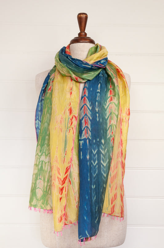 Neeru Kumar 100% silk shibori dyed scarf in lemon, lime, aqua and blue with highlights in vermilion red, tassels and edge stitching in pink.