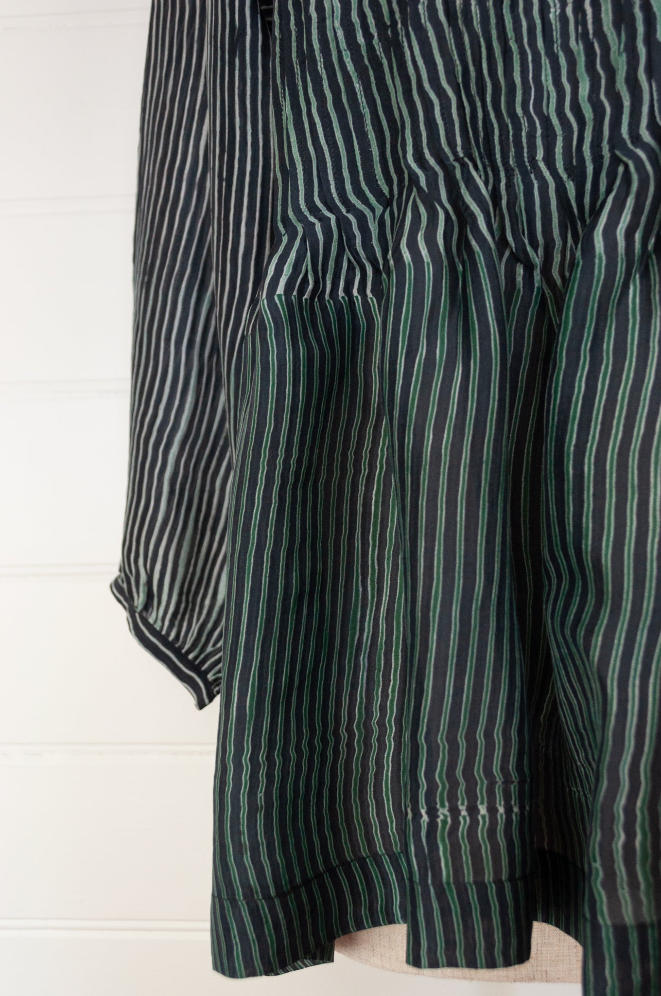 Juniper Hearth Asha top in deep marine, shibori dyed silk in shades of midnight navy and emerald green, long sleeve pintucked loose fitting round neck top.