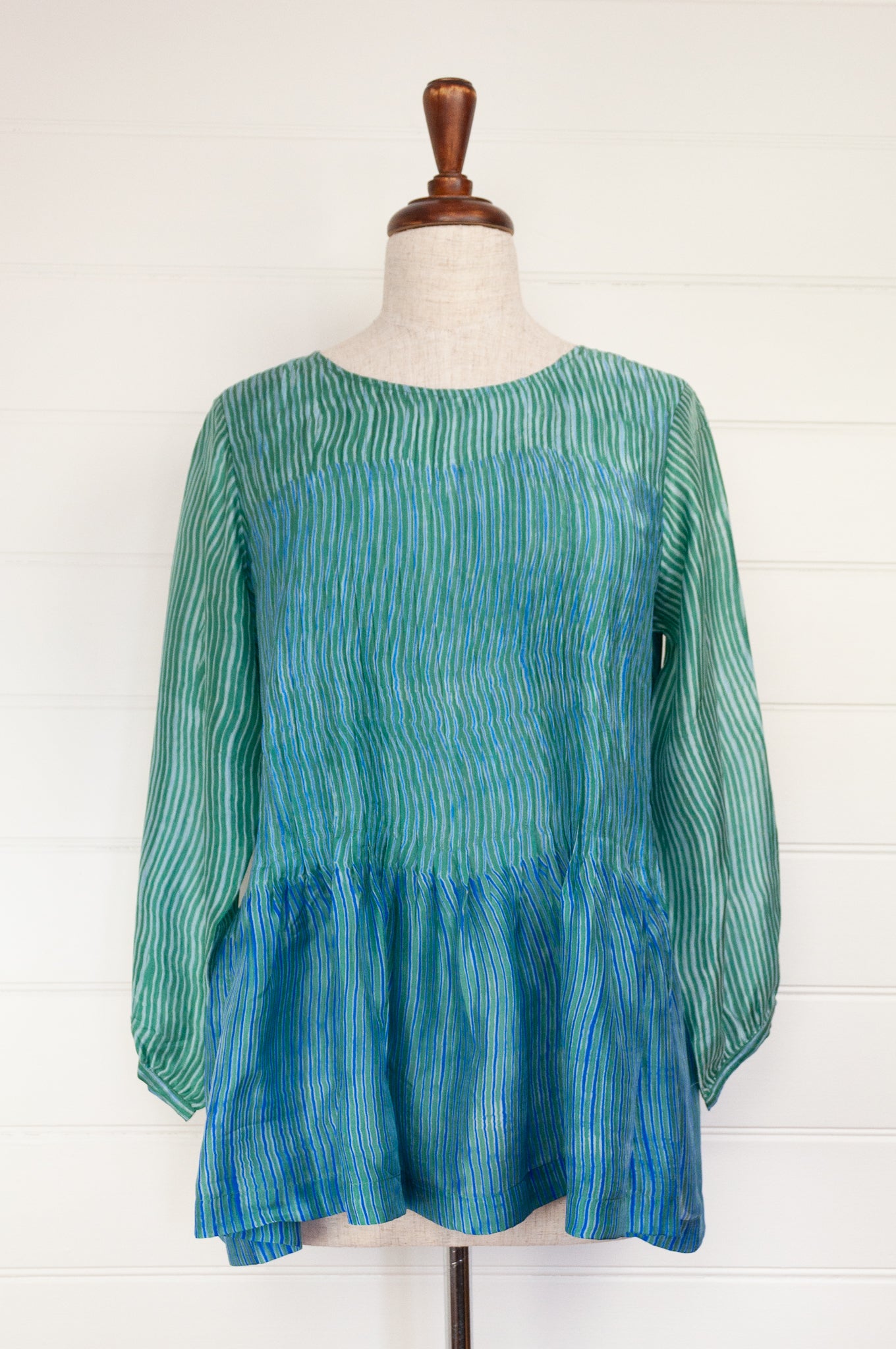 Juniper Hearth silk shibori Asha top with pin tucked bodice and long sleeves in aqua with vibrant blue accents.