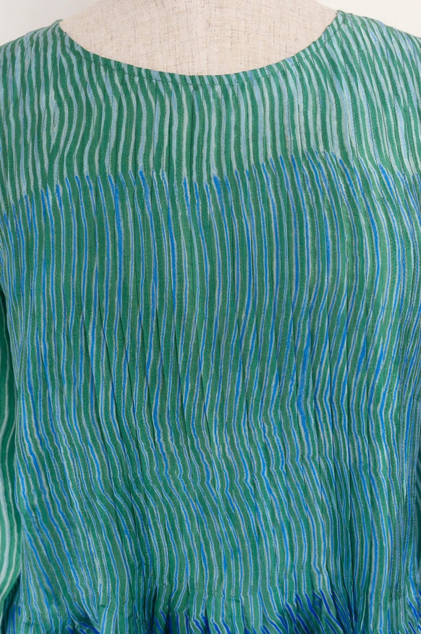 Juniper Hearth silk shibori Asha top with pin tucked bodice and long sleeves in aqua with vibrant blue accents.