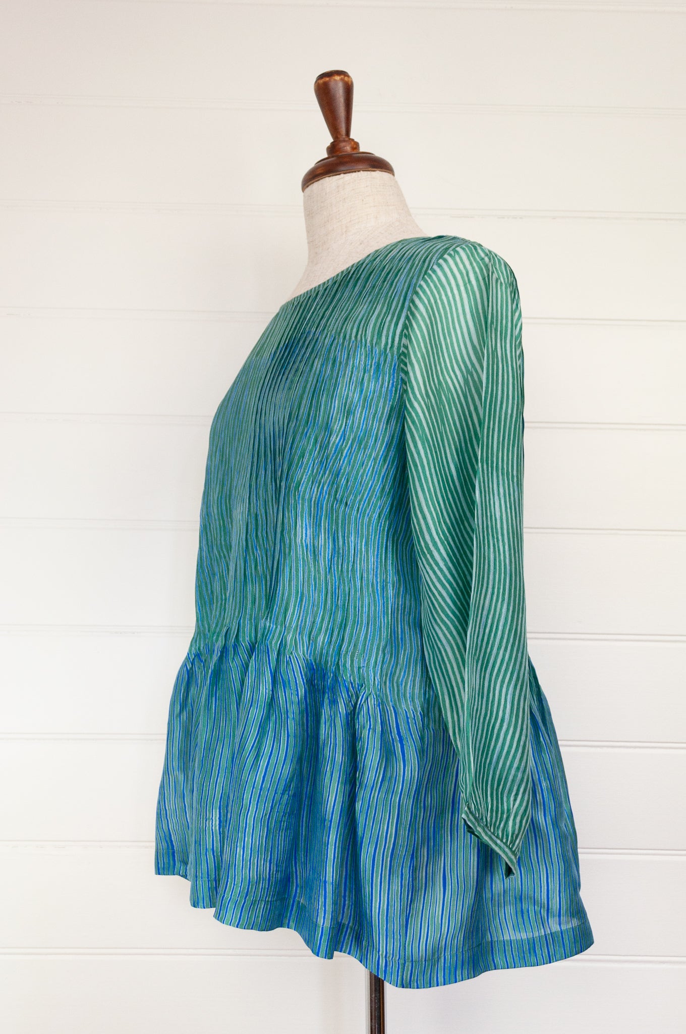 Juniper Hearth silk shibori Asha top with pin tucked bodice and long sleeves in aqua with vibrant blue accents.
