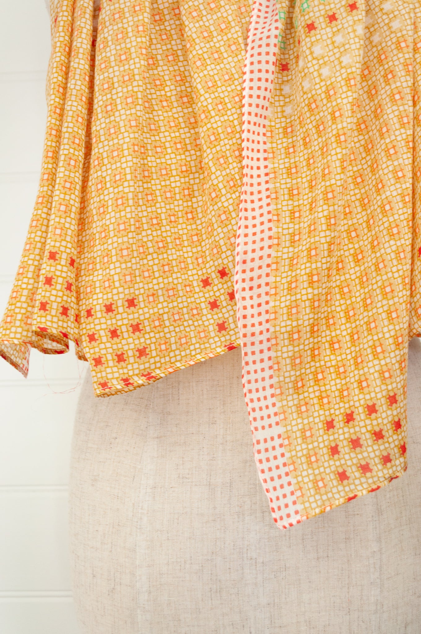 Anna Kaszer fine cotton voile scarf, geometric pattern in pale orange, aqua, red geometric design.