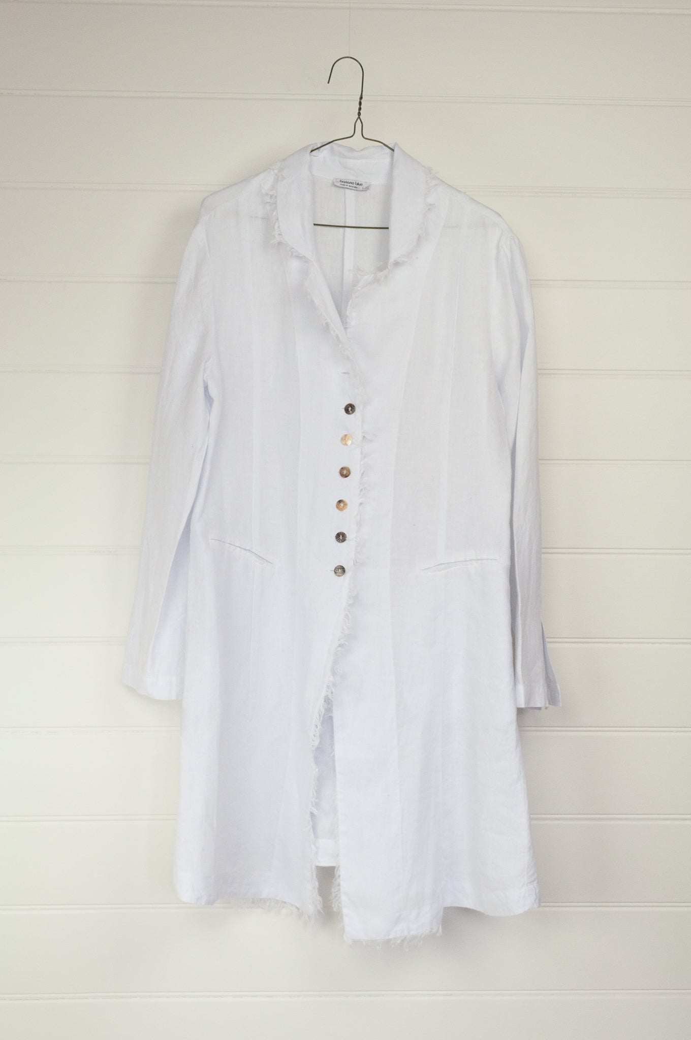Banana Blue long jacket duster coat in 100% European white linen, long sleeves half button up and fringed edges.