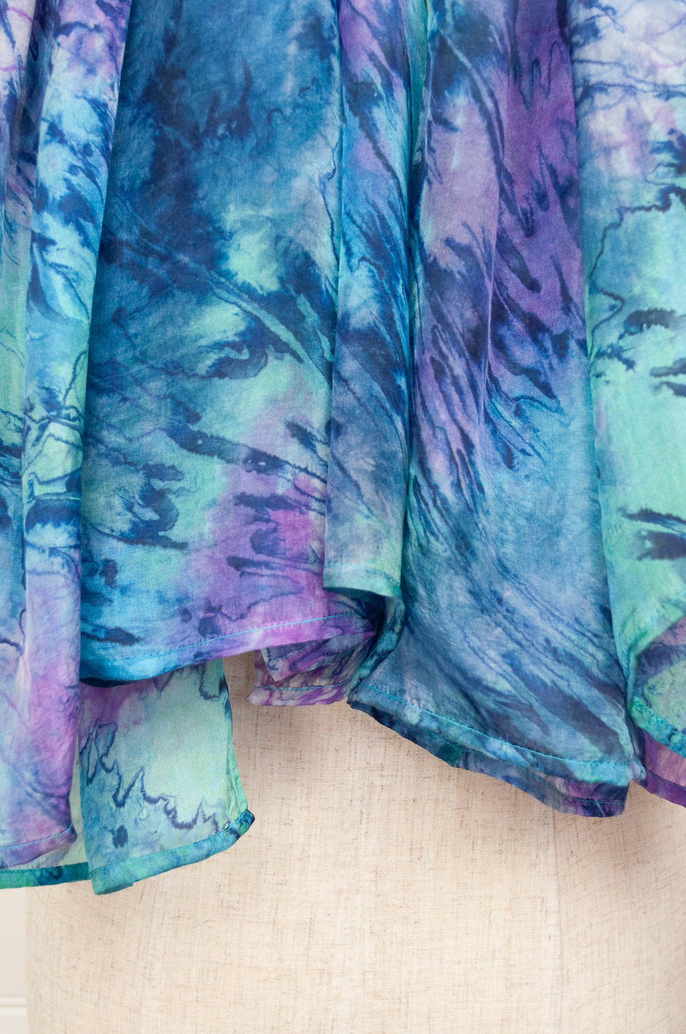 Digitally printed lightweight silk scarf in waterlily, shades of blue, mauve, lavender, aqua and teal.