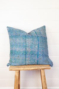 Vintage kantha quilt cushion, overdyed with blue and white blockprint chevron stripe pattern with red highlights.