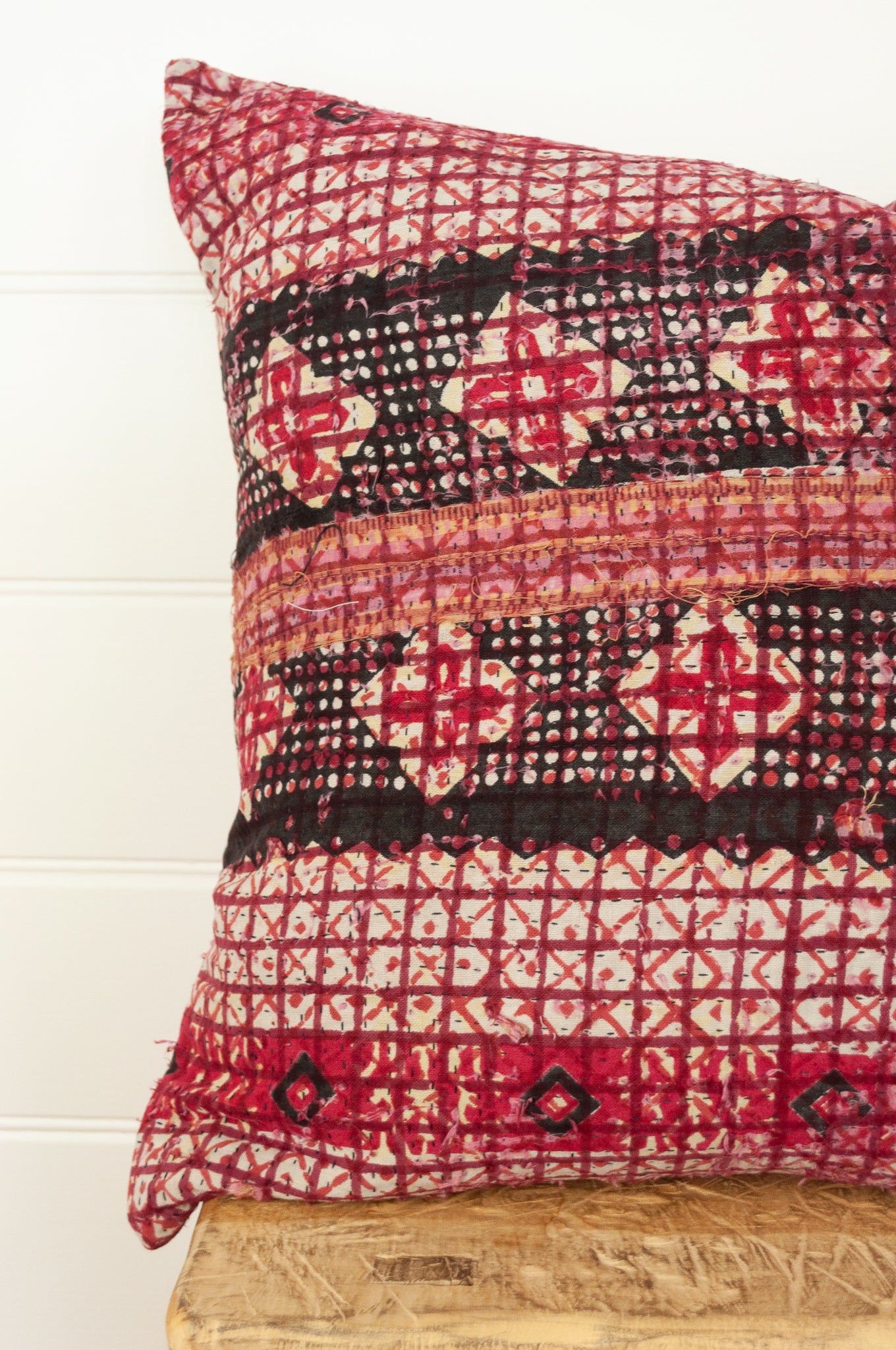 Vintage kantha quilt cushion, overdyed with red and white and black blockprint dotted check pattern.