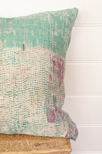 VIntage kantha quilt cushion in shades of mint green, white, blue and lavender.