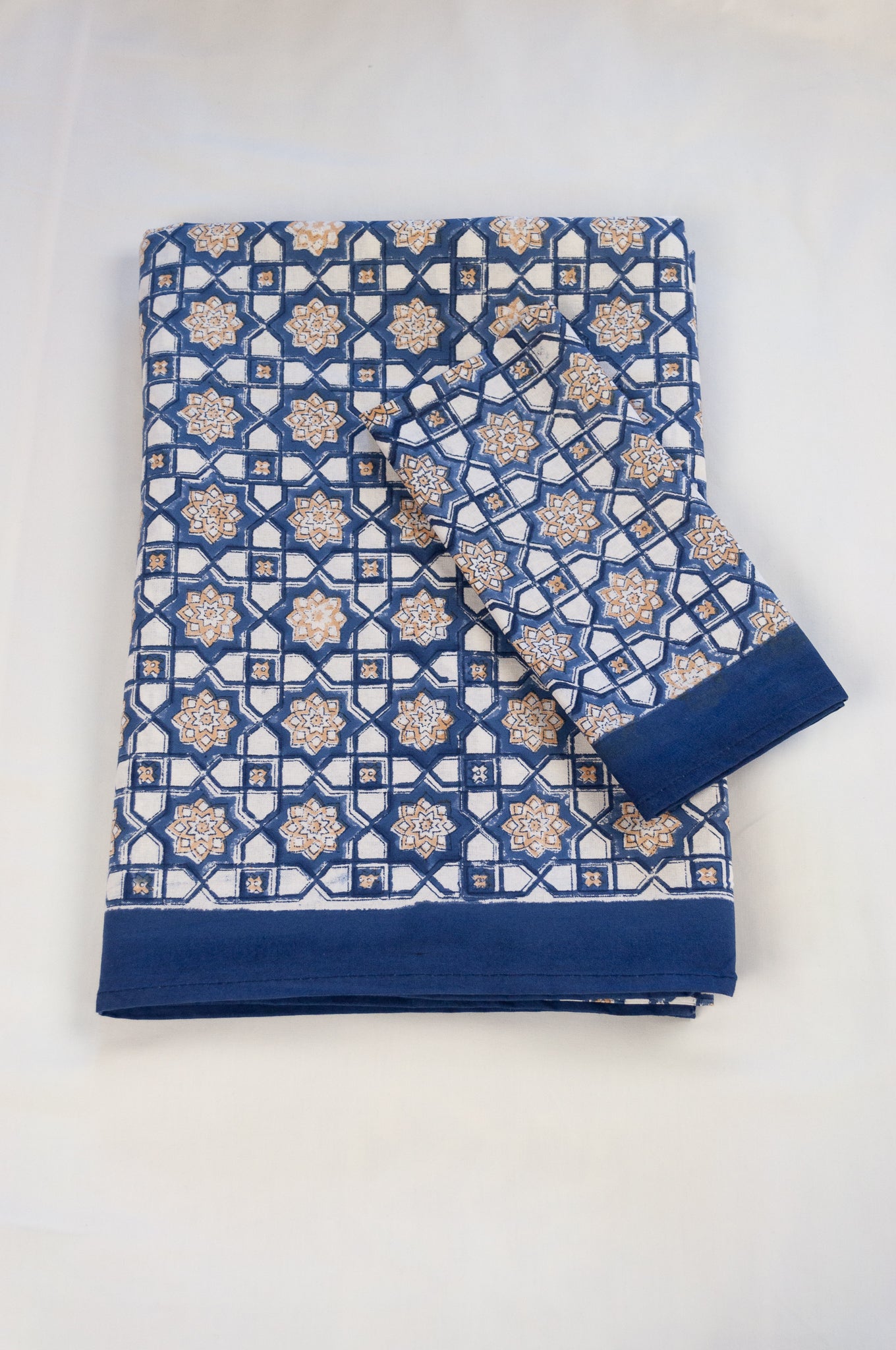 Blockprinted cotton table cloth, Almira Moroccan tile print in indigo denim blue and white with soft gold highlights.