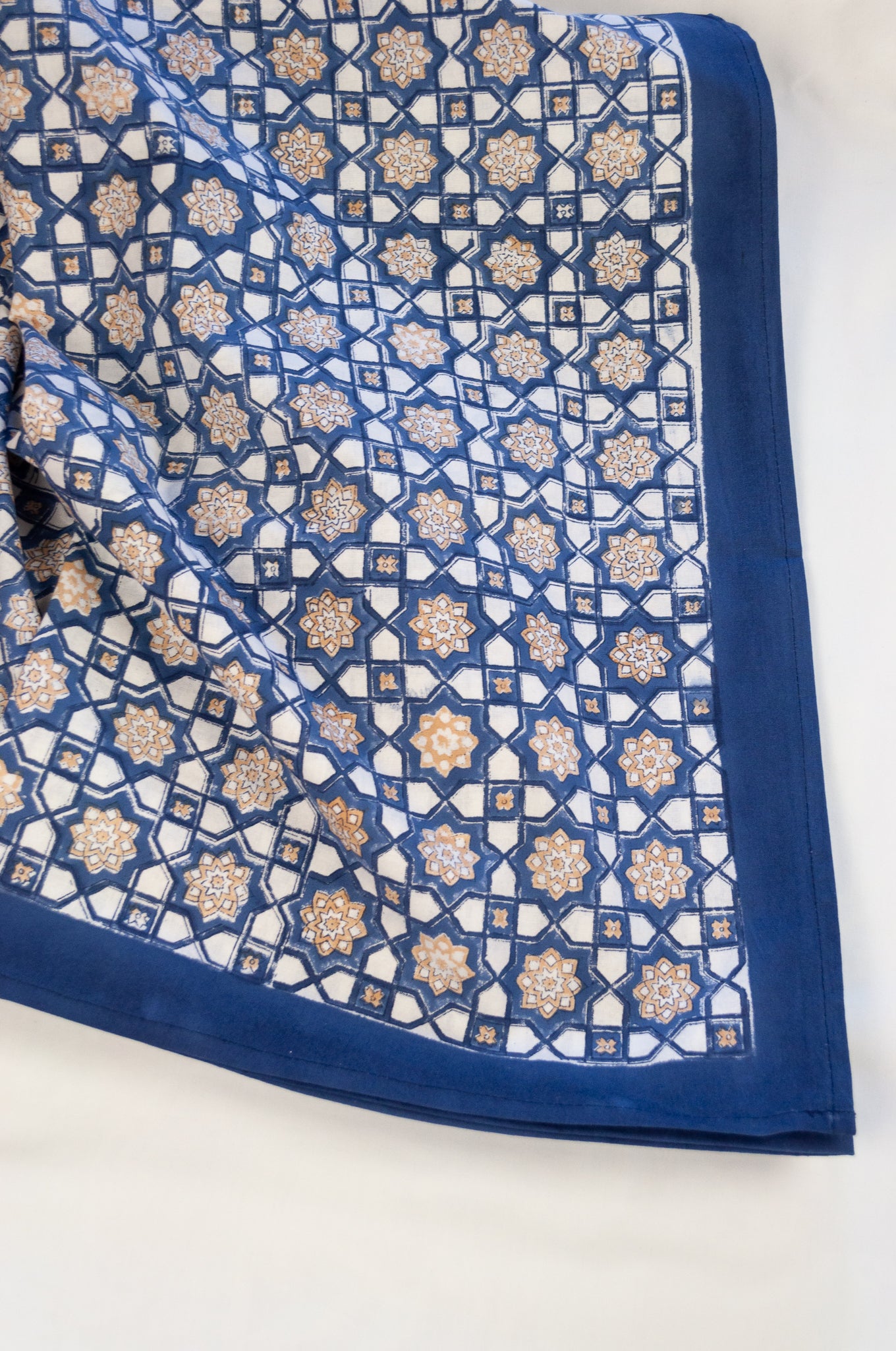 Blockprinted cotton table cloth, Almira Moroccan tile print in indigo denim blue and white with soft gold highlights.