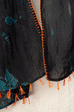 Load image into Gallery viewer, Neeru Kumar fine silk shibori dyed scarf, black with teal green patterning, edge stitched and tassels in neon orange.