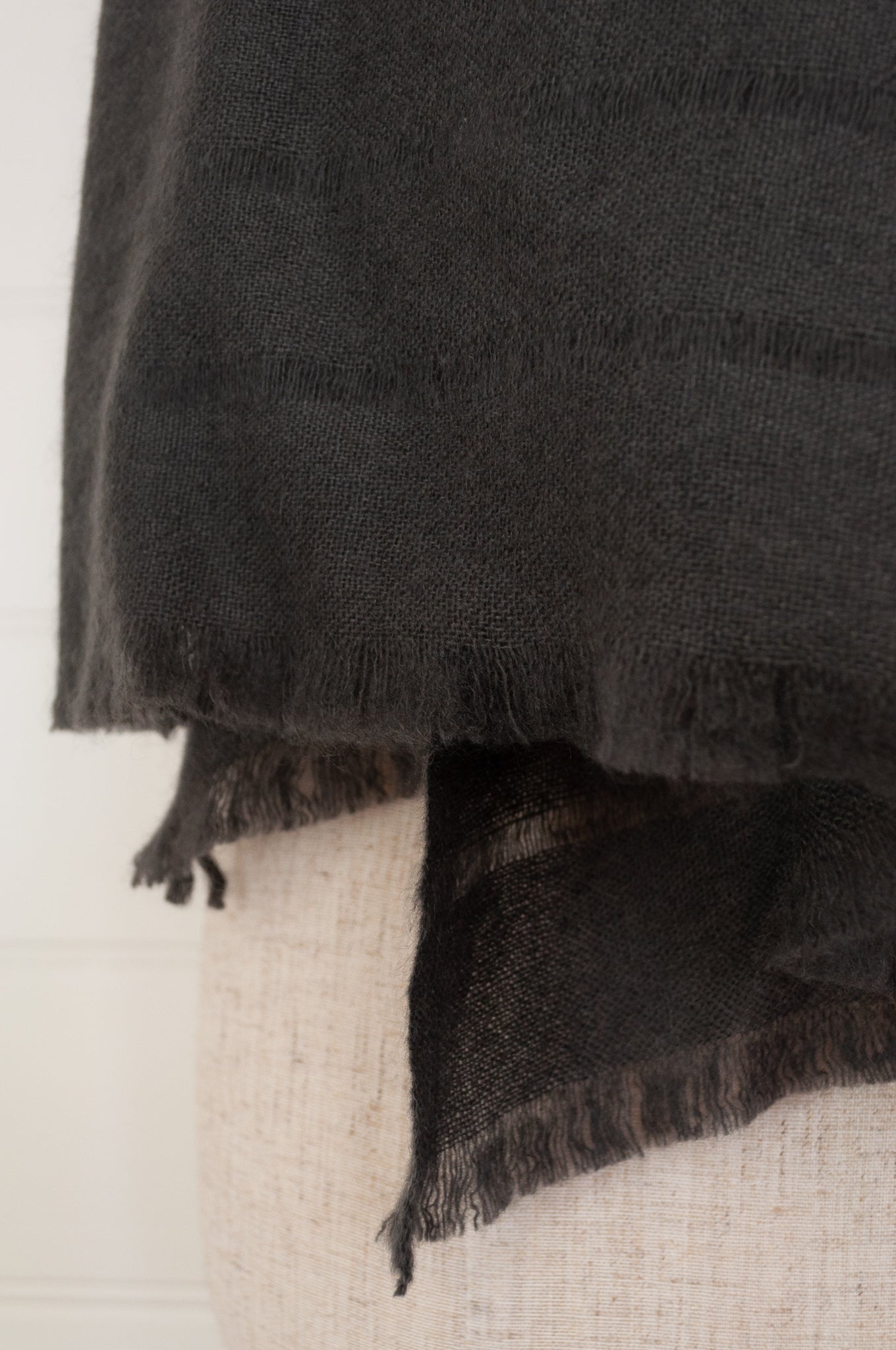 Juniper Hearth woven cashmere scarf featuring fagoting detail and fringed at ends, in charcoal.