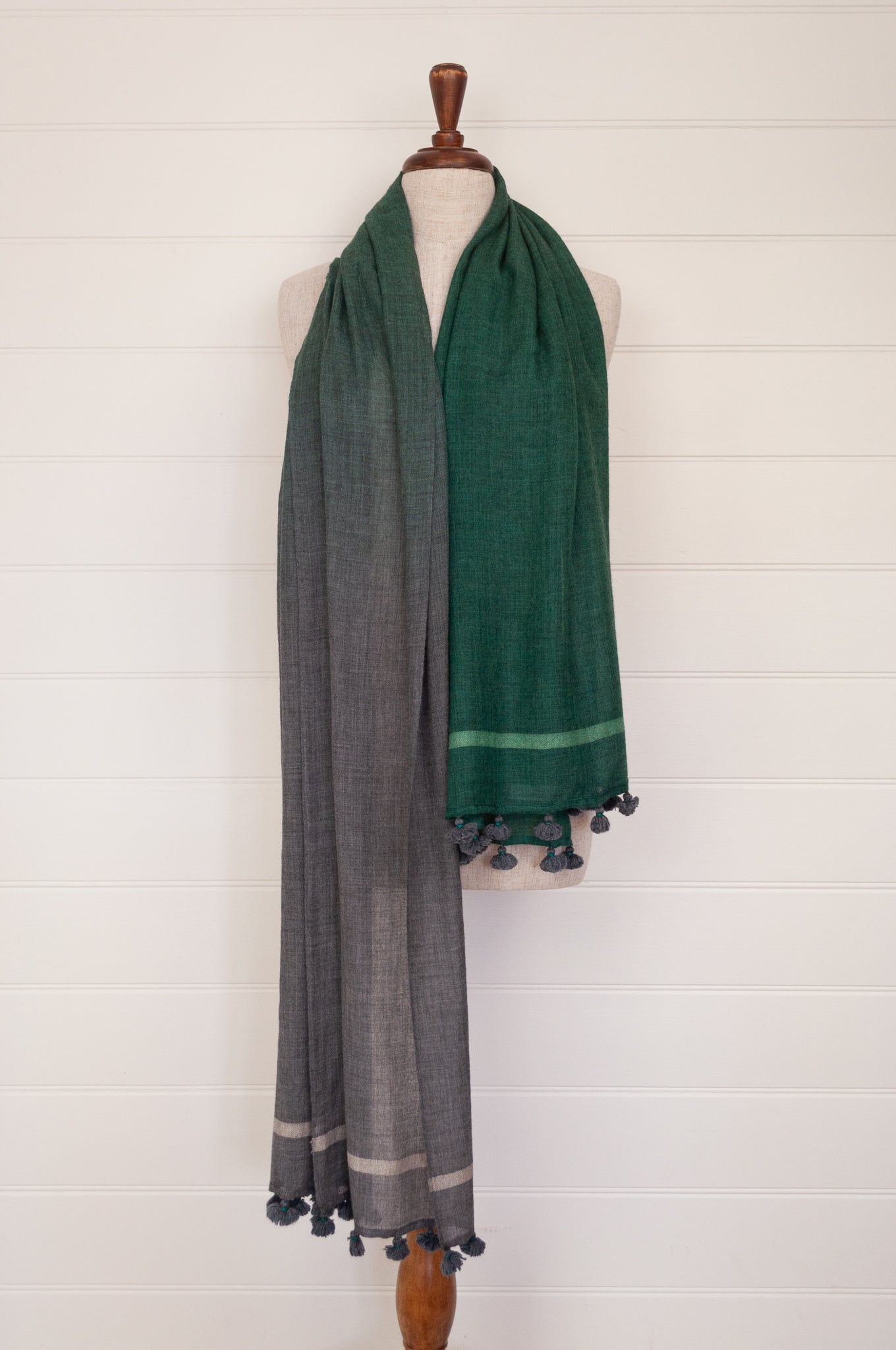 Juniper Hearth woven merino wool scarf, lightweight and very soft, melange dye from charcoal to jade green, with handmade pompoms.