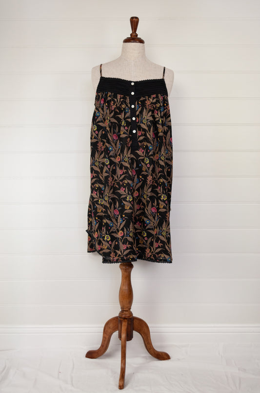 Ethically made pure cotton voile summer nightdress with adjustable straps and pintucked yoke, this nightie is in a wildflower print on black with broderie edging.