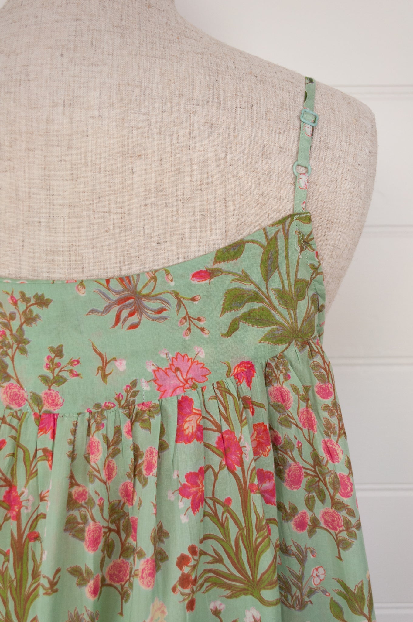 Ethically made pure cotton voile summer nightdress with adjustable straps and pintucked yoke, this nightie is in a mint green floral print with broderie edging (close up, adjustable strap)