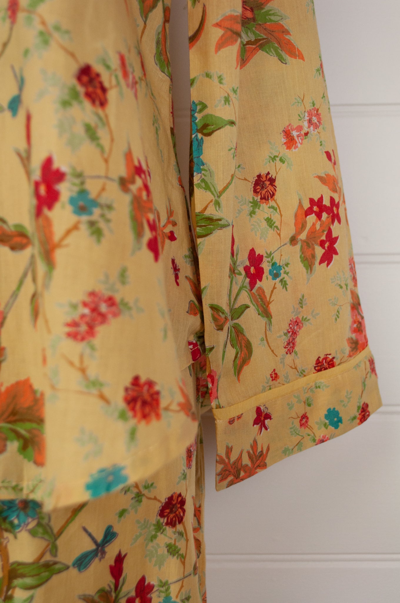 Ethically made cotton voile pyjamas, screen printed with a coral, raspberry and aqua floral print on sunshine yellow.