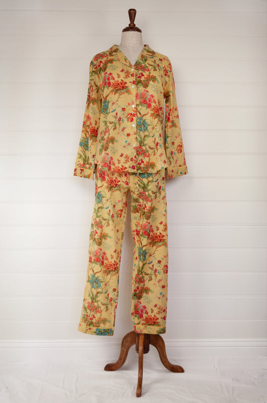Ethically made cotton voile pyjamas, screen printed with a coral, raspberry and aqua floral print on sunshine yellow.