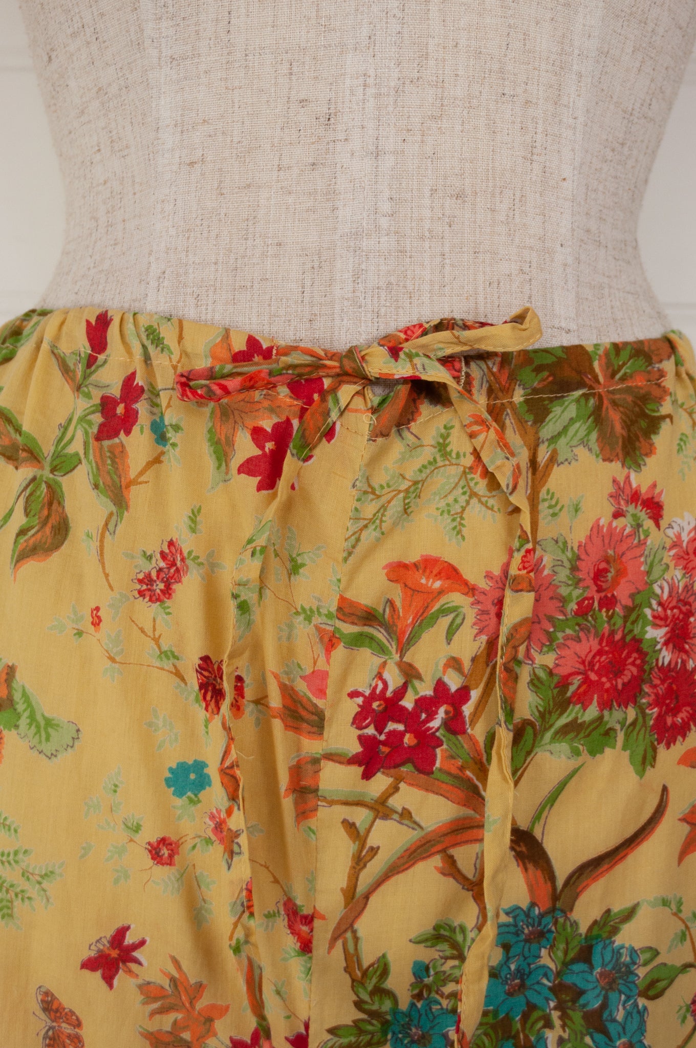 Ethically made cotton voile pyjamas, screen printed with a coral, raspberry and aqua floral print on sunshine yellow.