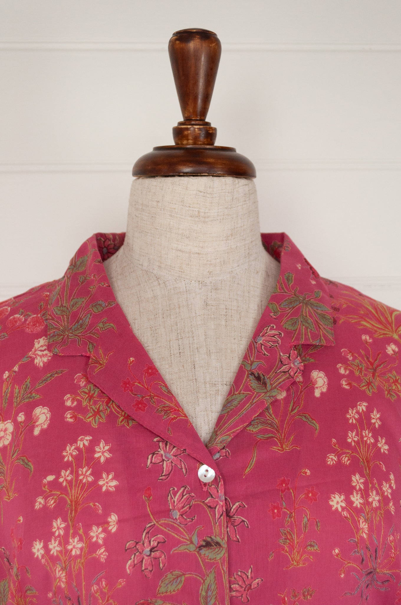 Ethically made cotton voile pyjamas with garden flowers of pink, red and vanilla on a deep raspberry pink red background.