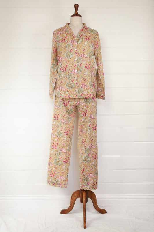 Ethically made cotton voile pyjamas featuring a print of palm trees, vines and butterflies in sage green, lemon and raspberry pink on a soft lime green background.