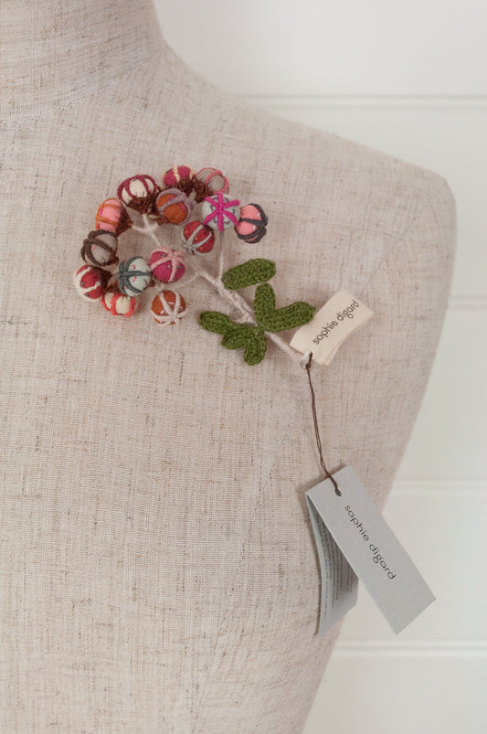 Sophie Digard hand made embroidered and crocheted linen flower brooch in light aqua, pinks and reds.