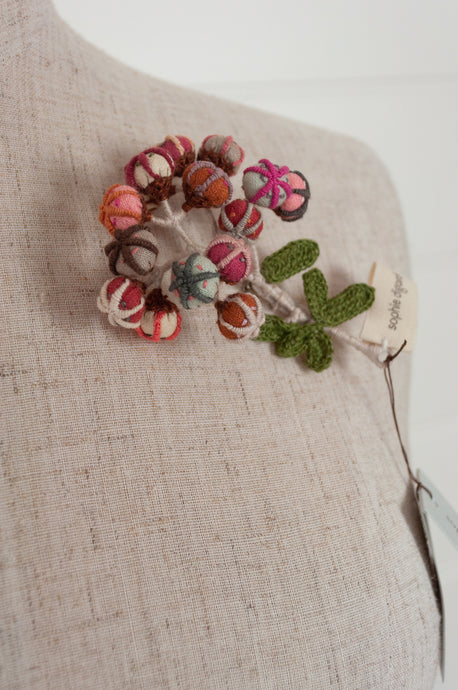 Sophie Digard hand made embroidered and crocheted linen flower brooch in light aqua, pinks and reds.