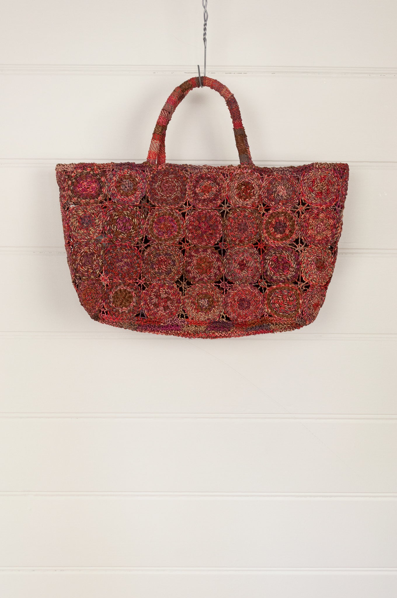 Sophie Digard handmade medium sized macrame raffia bag in shades of red.