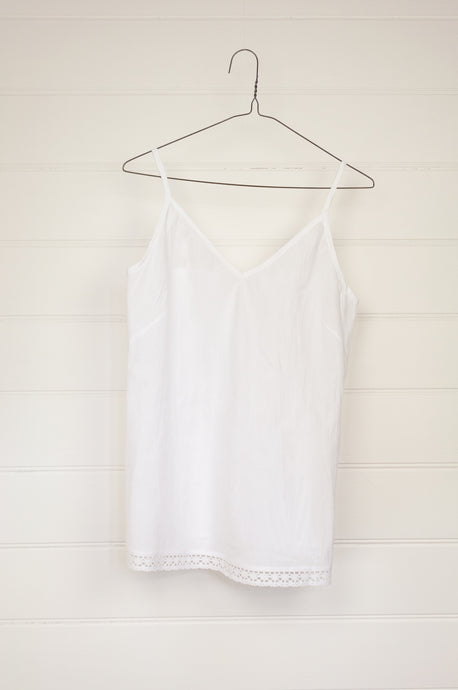 Cotton lace edged white cotton lightweight camisole bias cut with adjustable straps.