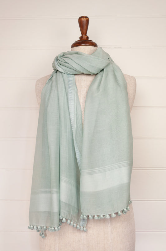Silk and cotton scarf with pom poms in light aqua celadon green.