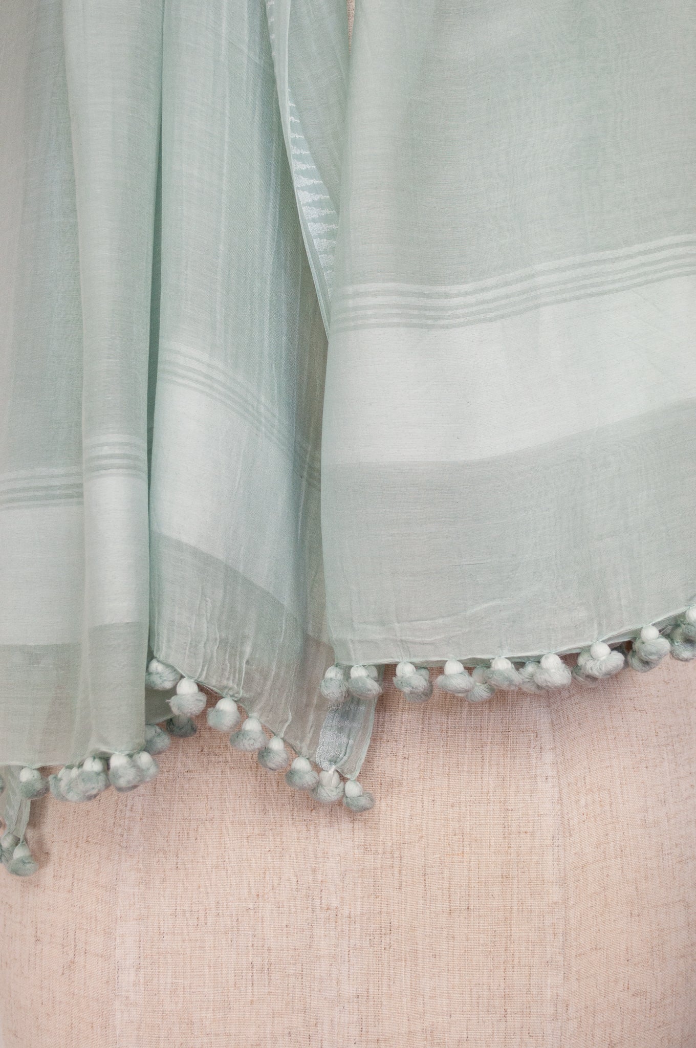 Silk and cotton scarf with pom poms in light aqua celadon green.