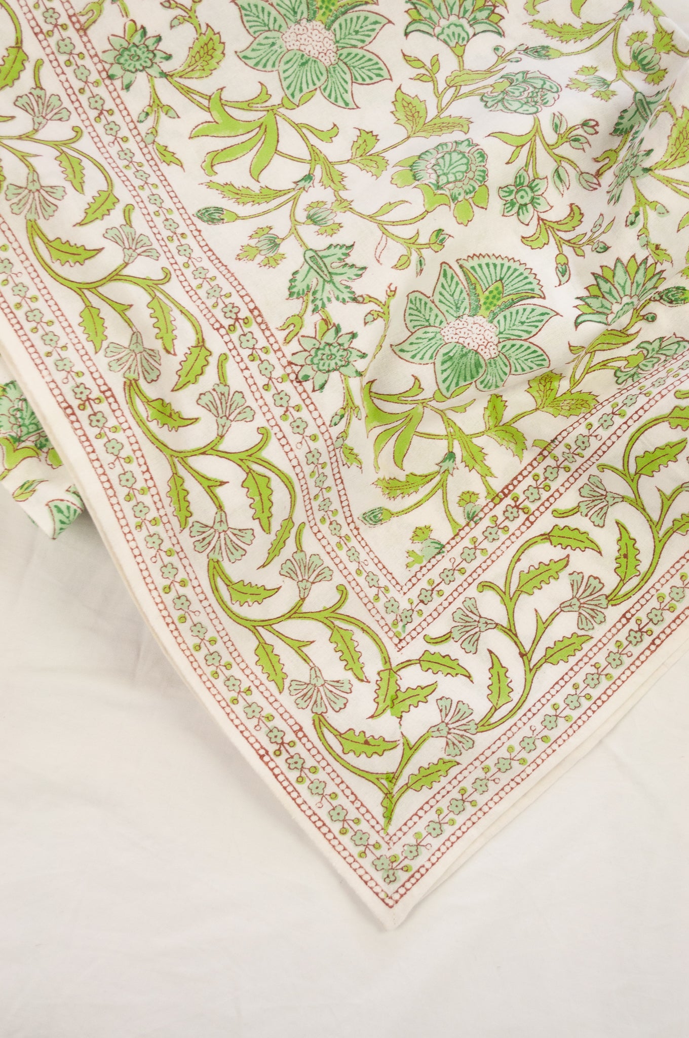 Cotton table cloth, blockprinted by hand exclusively for Juniper Hearth, Mina floral in turquoise and lime green on white.