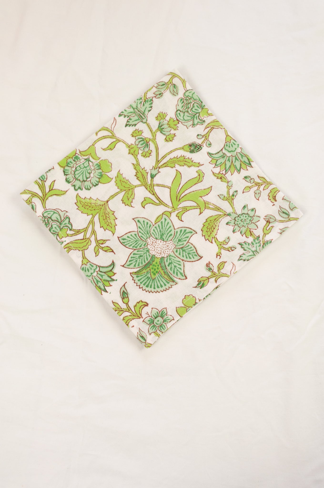 Cotton table napkins, blockprinted by hand exclusively for Juniper Hearth, Mina floral in turquoise and lime green on white.