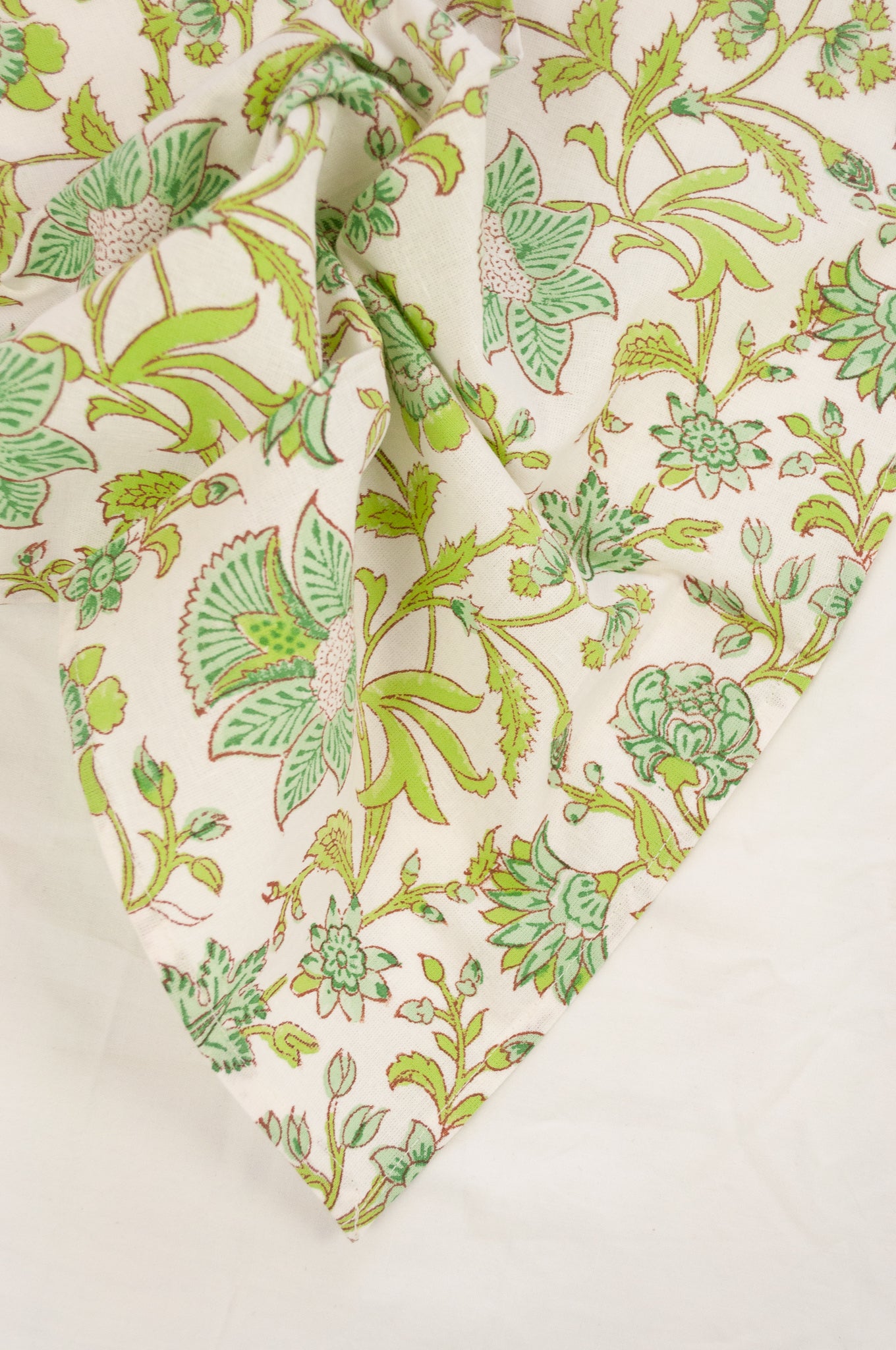 Cotton table napkins, blockprinted by hand exclusively for Juniper Hearth, Mina floral in turquoise and lime green on white.
