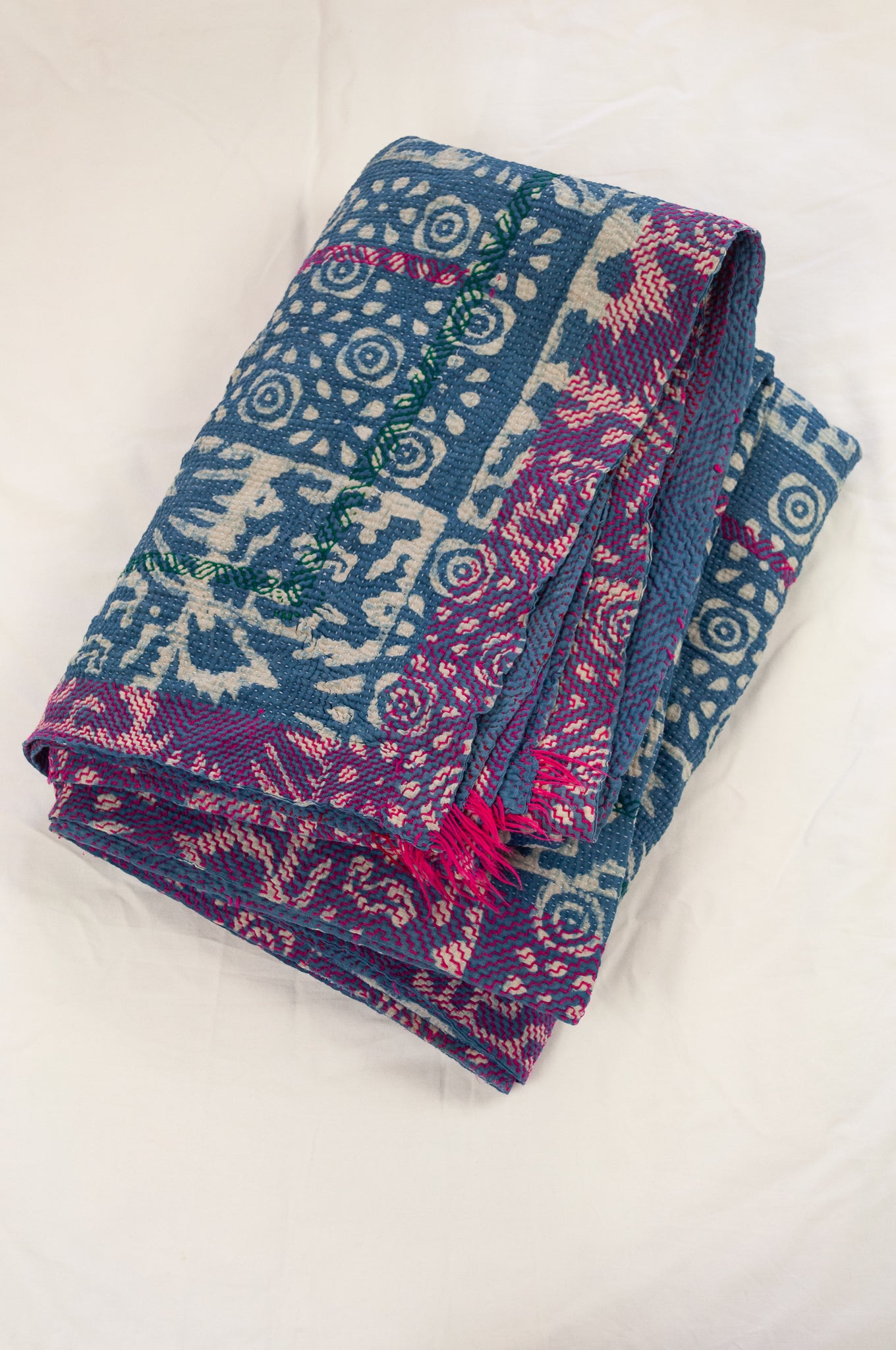 Vintage kantha quilt upcycled from cottonn saris, handstitched and overdyed with mud resist in natural indigo, and brilliant pink border stitching.