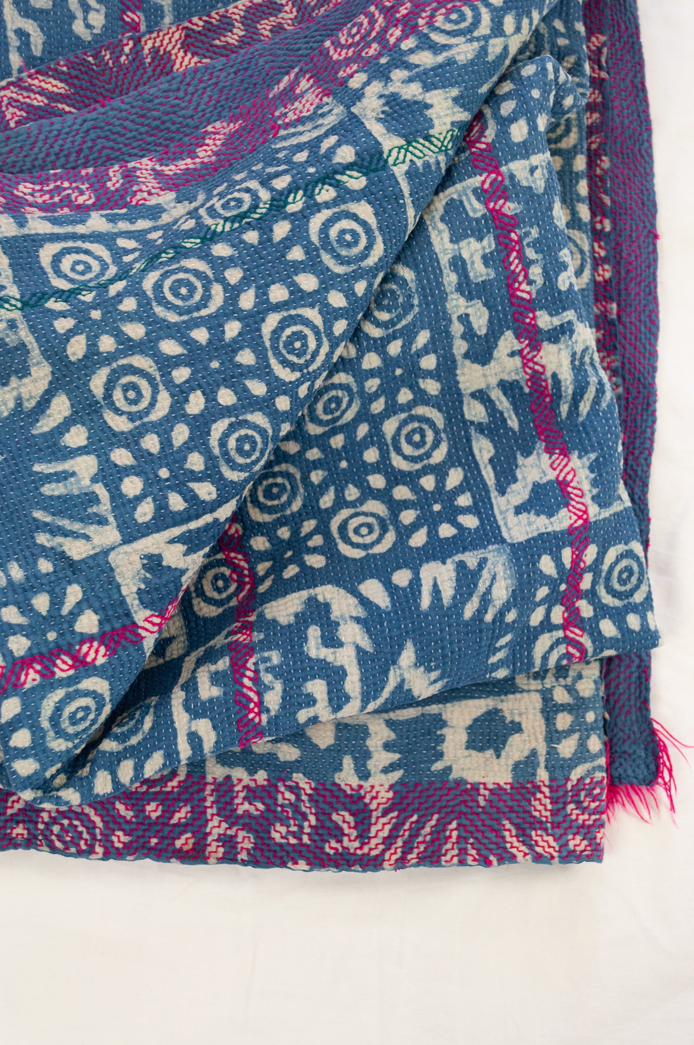 Vintage kantha quilt upcycled from cottonn saris, handstitched and overdyed with mud resist in natural indigo, and brilliant pink border stitching.