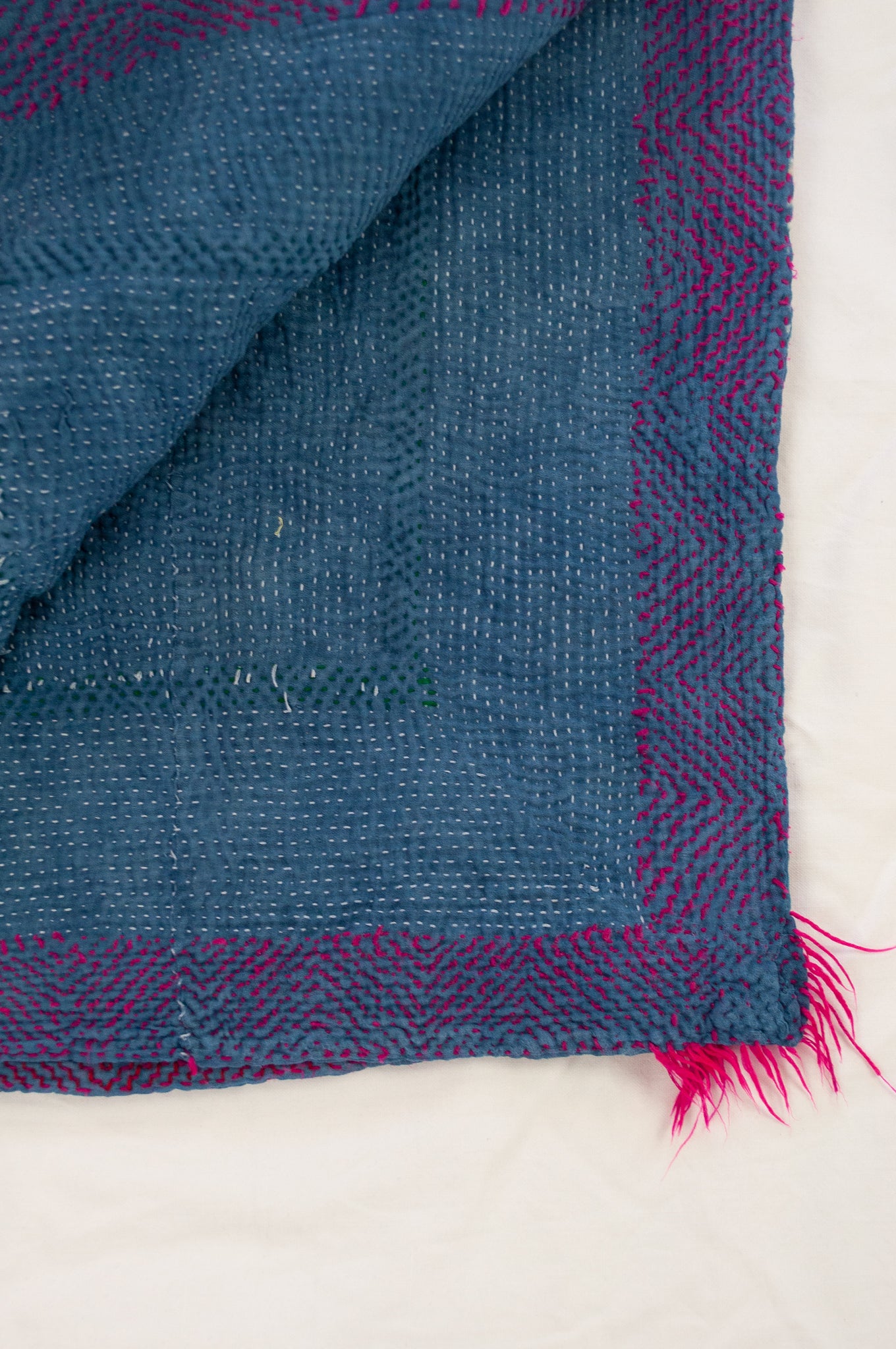 Vintage kantha quilt upcycled from cottonn saris, handstitched and overdyed with mud resist in natural indigo, and brilliant pink border stitching.
