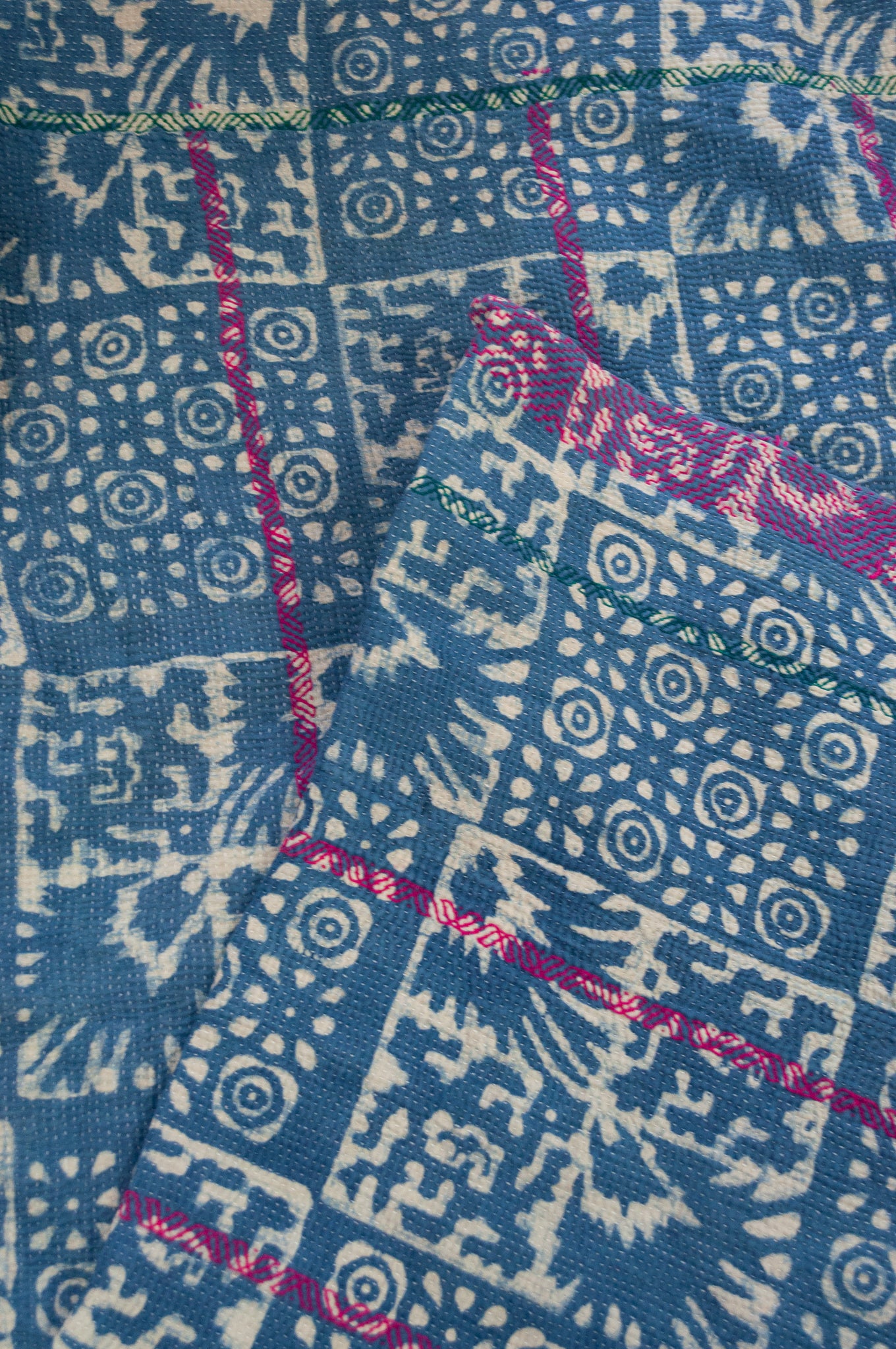 Vintage kantha quilt upcycled from cottonn saris, handstitched and overdyed with mud resist in natural indigo, and brilliant pink border stitching.