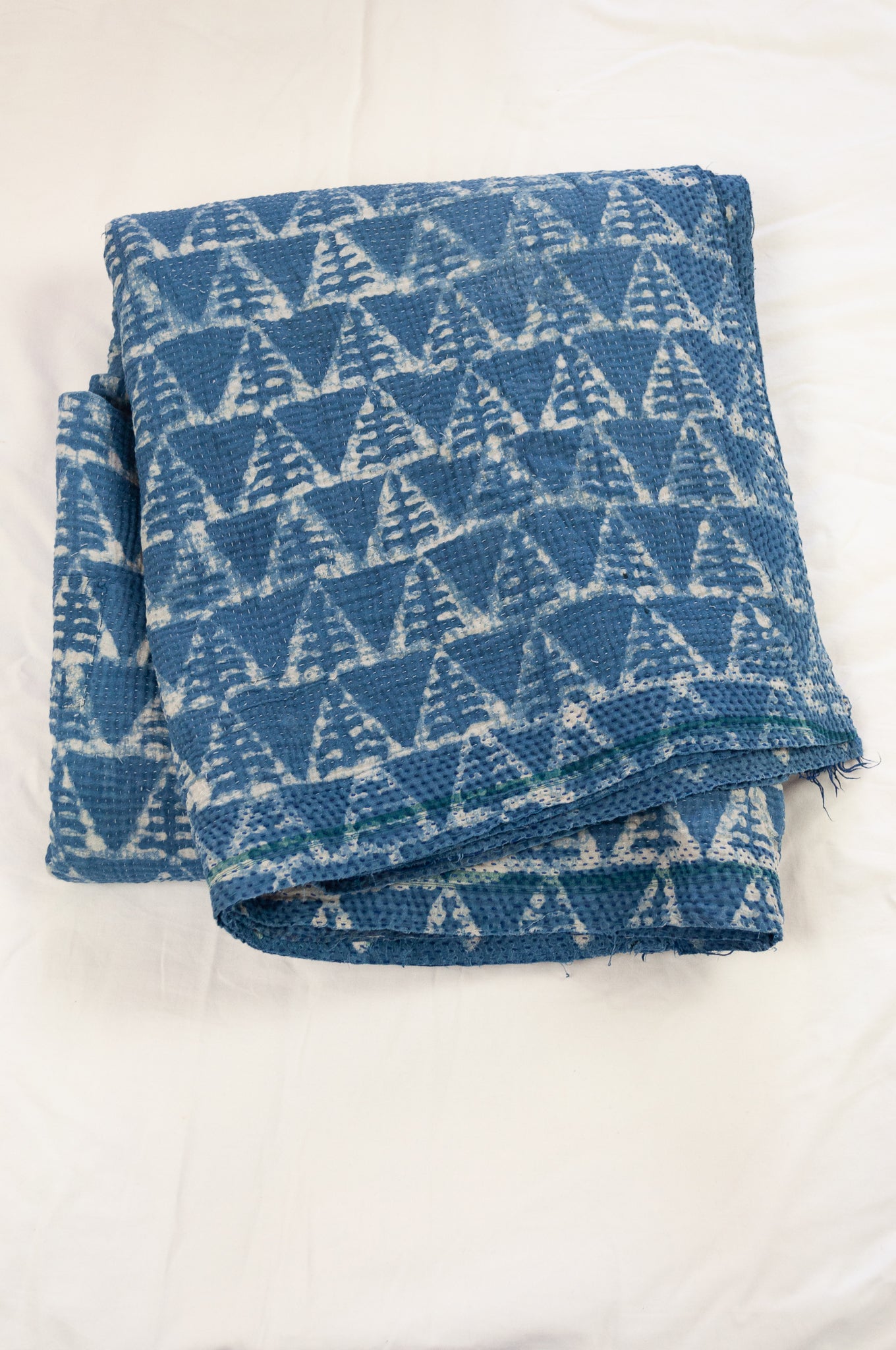 Vintage kantha quilt upcycled from cottonn saris, handstitched and overdyed with mud resist in natural indigo.