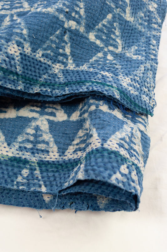 Vintage kantha quilt upcycled from cottonn saris, handstitched and overdyed with mud resist in natural indigo.