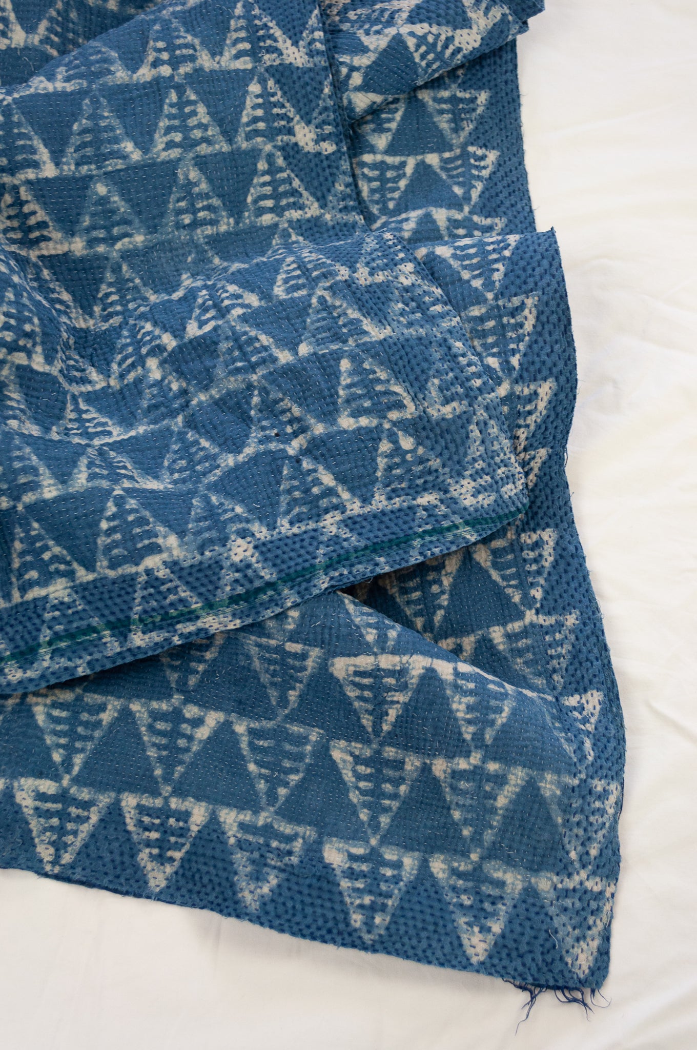 Vintage kantha quilt upcycled from cottonn saris, handstitched and overdyed with mud resist in natural indigo.