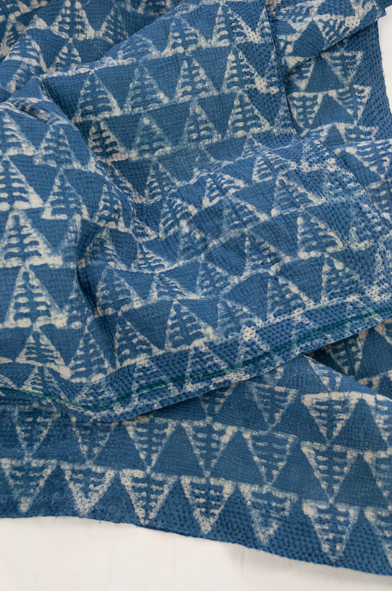 Vintage kantha quilt upcycled from cottonn saris, handstitched and overdyed with mud resist in natural indigo.