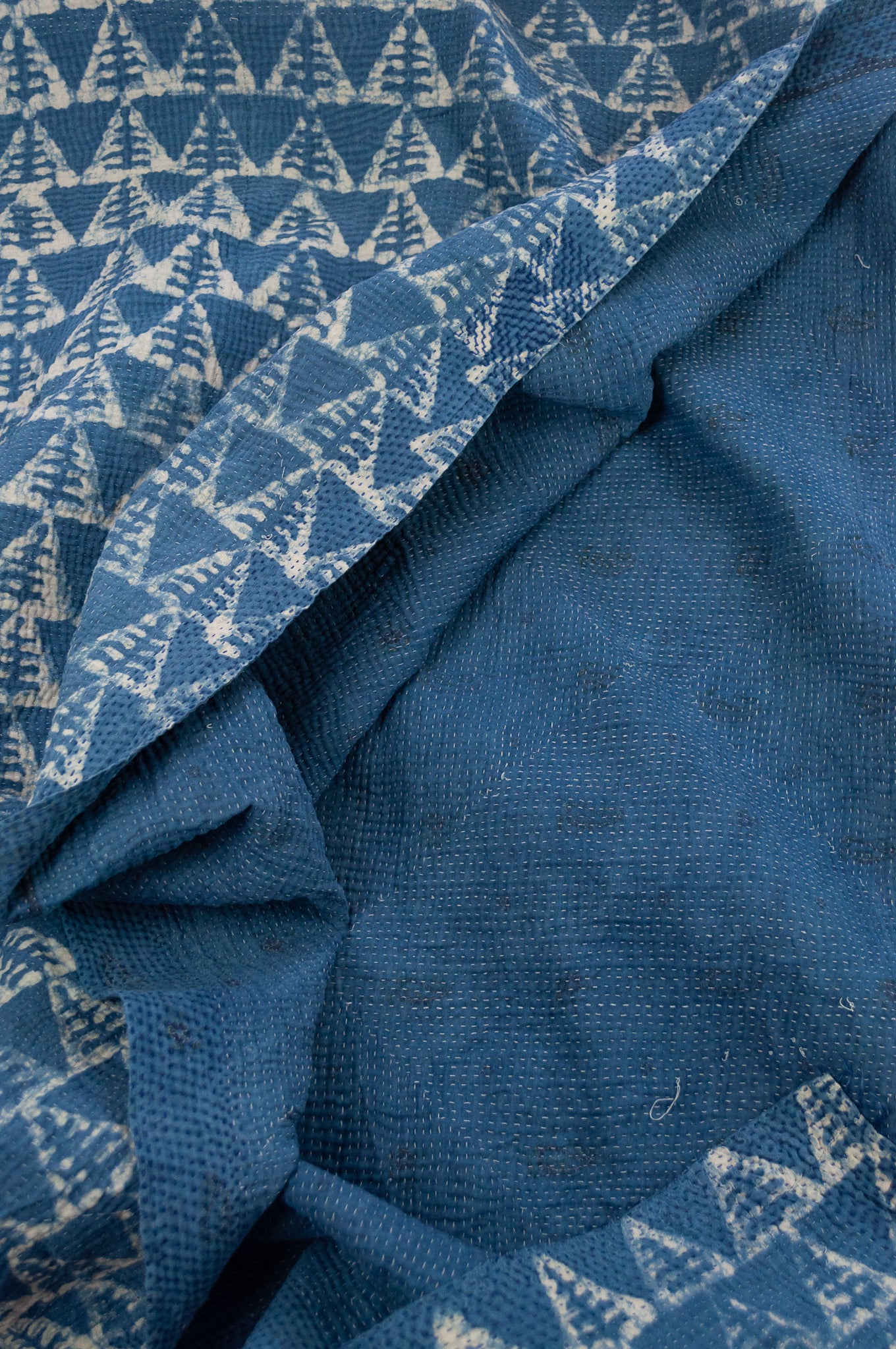 Vintage kantha quilt upcycled from cottonn saris, handstitched and overdyed with mud resist in natural indigo.